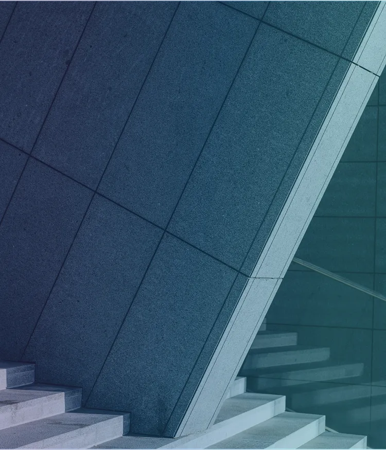 Close-up of a staircase and a heavy-looking concrete structure.