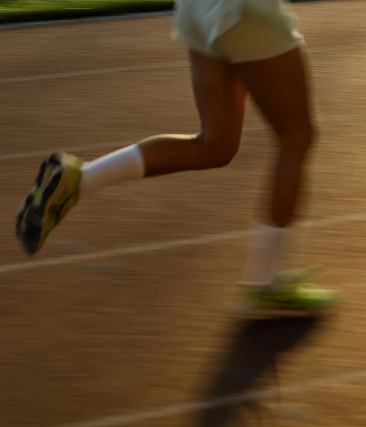 Close-up of a female runner’s legs with motion blur.