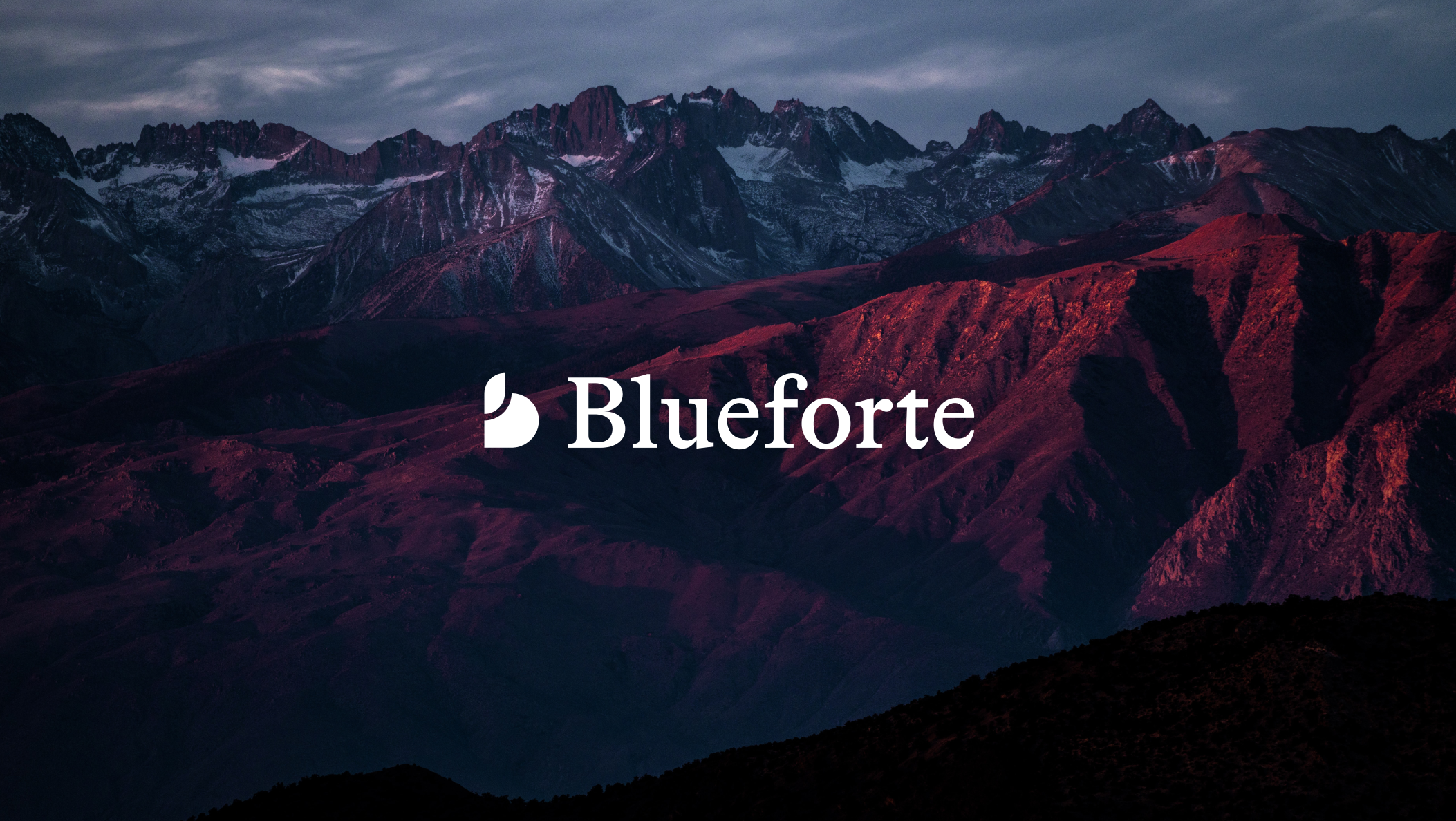 Blueforte logo prominently displayed on a mountain against a striking red sky backdrop.