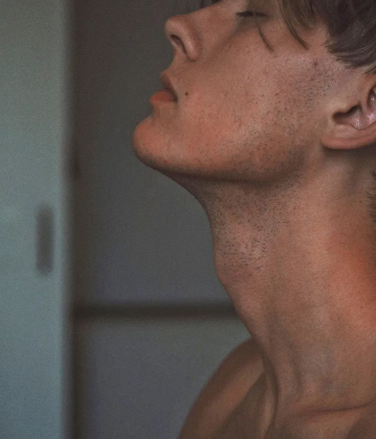 A close-up of a man meditating.