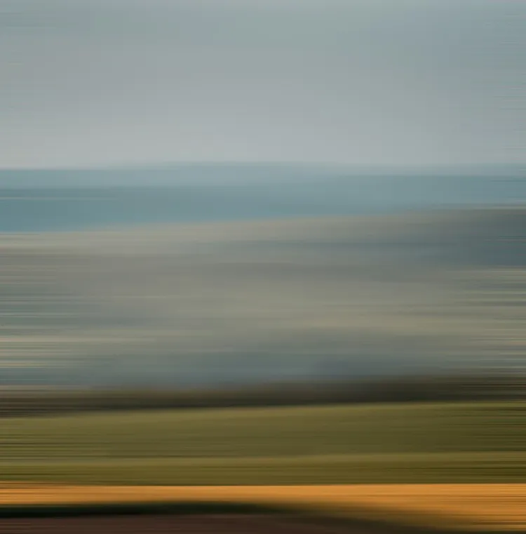 An abstract image with horizontal, blurred lines in shades of blue, green, and brown, reminiscent of a landscape.
